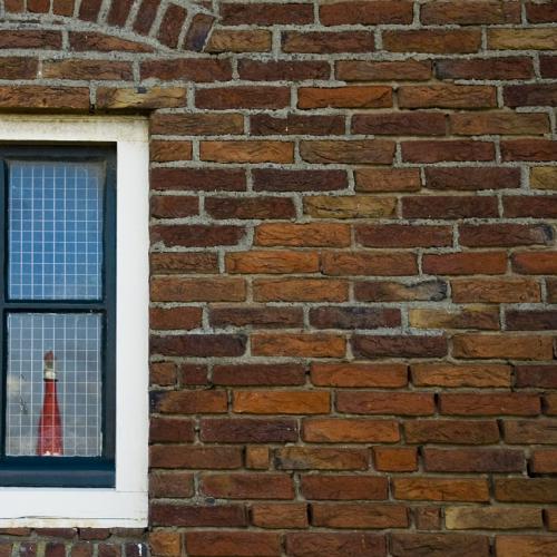 Light house in window in brick wall